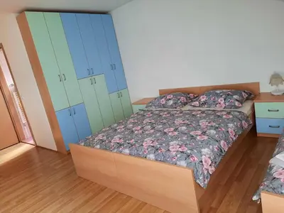 a bedroom with a bed with blue and green cabinets at Tourist Farm Lavrič in Woditz