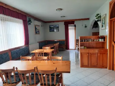 a dining room with wooden tables and chairs at Tourist Farm Lavrič in Woditz