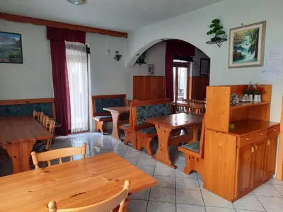 a dining room with wooden tables and chairs at Tourist Farm Lavrič in Woditz