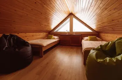 a room with two beds and a window in a cabin at Apartments & Rooms Malej in Bohinj