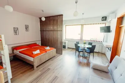a bedroom with a bed and a table and chairs at Frankovič Bed&Breakfast in Vinica