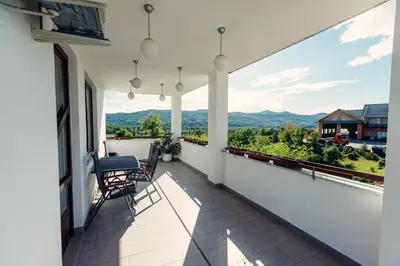 a balcony with chairs and a view of the mountains at Frankovič Bed&Breakfast in Vinica