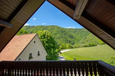 a view from the balcony of a house with a mountain at Tourist Farm Zelinc in Cerkno
