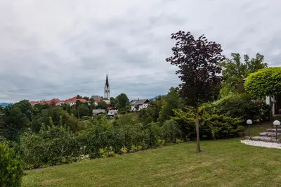 a view of a town with a church in the distance at Apartma Spaans in Radovljica