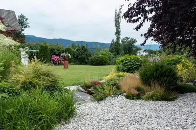 a garden with rocks and plants and a yard at Apartma Spaans in Radovljica