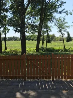 a wooden fence with a field in the background at Apartma, Prekmurska vas, Trobentica 32 in Moravske Toplice
