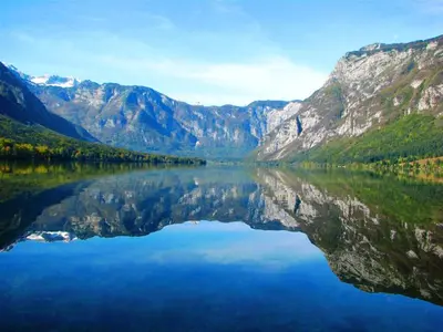 a large body of water with mountains in the background at Apartment Kolman in Bohinj