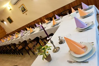 a group of tables with plates and napkins on them at Rooms Pevc & Hostel Ljubno ob Savinji in Ljubno