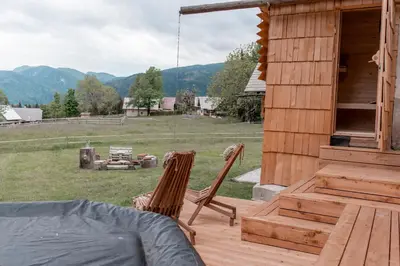 two chairs and a bed on a porch of a cabin at Holiday House Franc in Srednja Vas v Bohinju