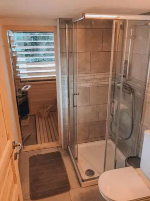 a bathroom with a shower and a toilet at Holiday House Franc in Srednja Vas v Bohinju