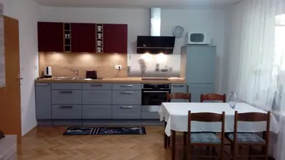 a kitchen with a table with a white table cloth on it at Apartma Meta in Radovljica