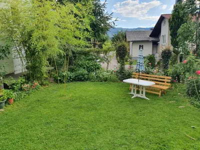 a picnic table and a bench in a yard at Apartma Meta in Radovljica