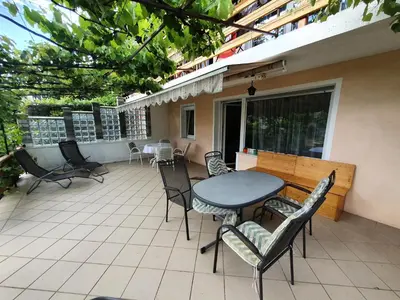 a patio with a table and chairs on a balcony at Apartma Meta in Radovljica