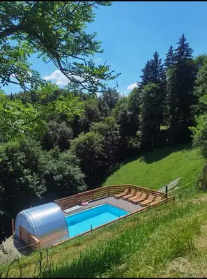 a swimming pool next to a metal trailer at Robida in Vransko