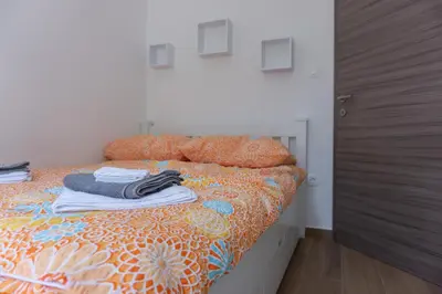 a bedroom with a bed with clothes on it at Nature View House with Sauna in Tolmin