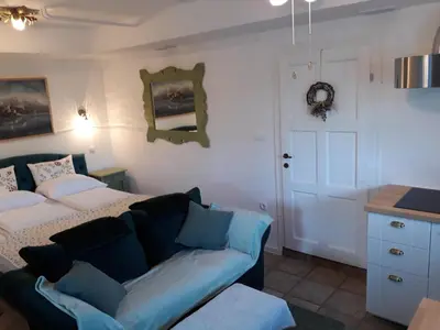a living room with a bed and a couch at Pletna Lake View Apartment (Ground Floor) in Bled