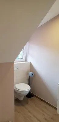 a bathroom with a toilet and a window at Resort Vidmar near Bled - rooms Vidmar in Lesce