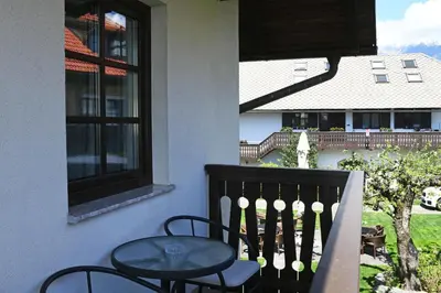 a balcony with a table and chairs and a window at Resort Vidmar near Bled - rooms Vidmar in Lesce