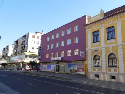 a group of buildings on a city street at Hotel Zvezda in Murska Sobota