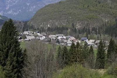 a group of houses in front of a mountain at Farmhouse Soklic in Bohinj