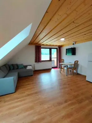 a living room with a couch and a table at Farmhouse Soklic in Bohinj