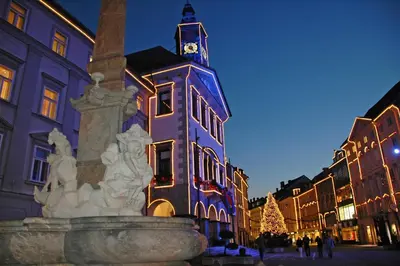 a building with a clock tower on top of a fountain at Hugo's House in Rakitna