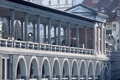 a bridge with columns and a building with people on it at Hugo's House in Rakitna