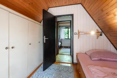 a small room with a bed and a hallway at Hugo's House in Rakitna