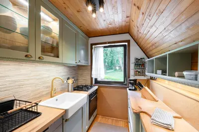 a kitchen with a sink and a window at Hugo's House in Rakitna