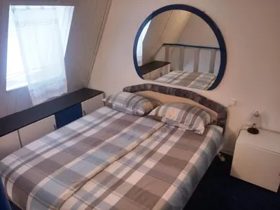 a small bedroom with two beds and a mirror at Beti Blu, Kaninska vas in Bovec