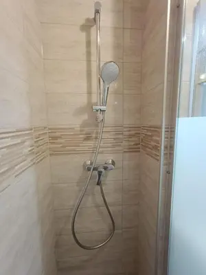 a shower with a shower head in a bathroom at Beti Blu, Kaninska vas in Bovec