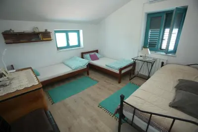 a living room with a bed and a couch at Vila Salamander in Štanjel