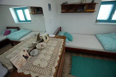 a room with two beds and a table in a room at Vila Salamander in Štanjel