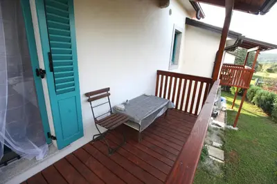 a porch with a table and chairs on a house at Vila Salamander in Štanjel