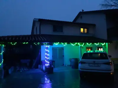 a house with christmas lights on the front of it at Vila Salamander in Štanjel