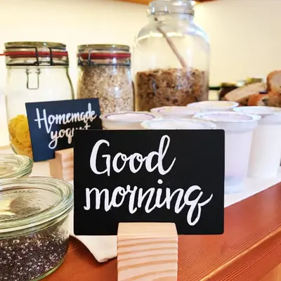 a good morning sign on a counter with jars of food at Pr'Gavedarjo Eco Heritage B&B in Kranjska Gora
