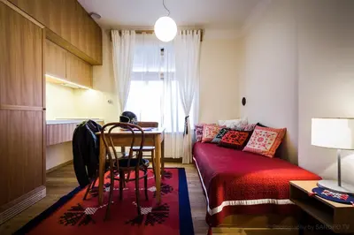 a bedroom with a bed and a table and chairs at Pr'Gavedarjo Eco Heritage B&B in Kranjska Gora