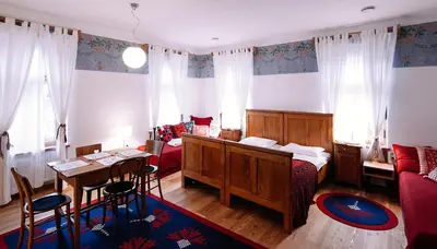a bedroom with a bed and a table and chairs at Pr'Gavedarjo Eco Heritage B&B in Kranjska Gora