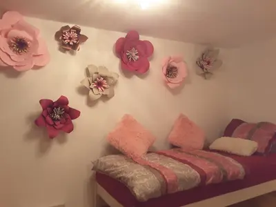 a room with a bed and flowers on the wall at DELUX duplex apartment in Maribor