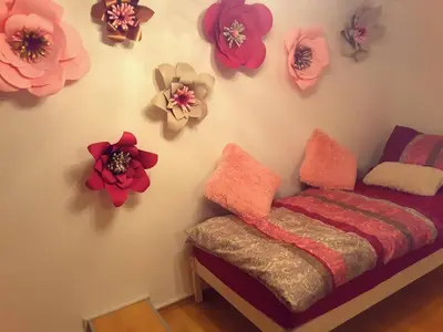 a room with a bed and flowers on the wall at DELUX duplex apartment in Maribor