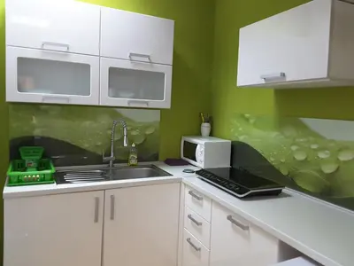 a kitchen with a sink and a laptop on a counter at DELUX duplex apartment in Maribor