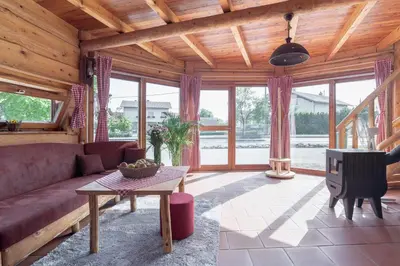 a living room with a couch and a tv at Wellness hiska Izabela in Križevci pri Ljutomeru