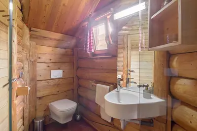 a bathroom with a white sink and a toilet at Wellness hiska Izabela in Križevci pri Ljutomeru