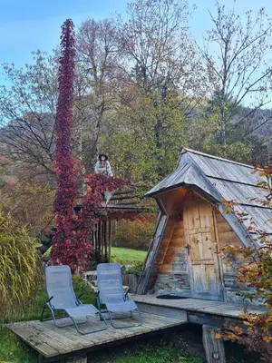 two chairs sitting on a deck next to a play house at Lepa Lopa resort in Stahovica