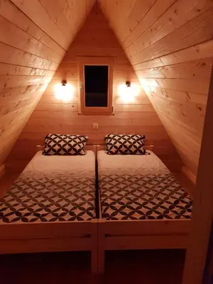 a small room with two beds in a cabin at Lepa Lopa resort in Stahovica