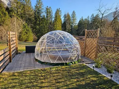 a large glass dome sitting in a yard next to a fence at Lepa Lopa resort in Stahovica