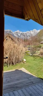 a view from the porch of a house with mountains in the background at Lepa Lopa resort in Stahovica