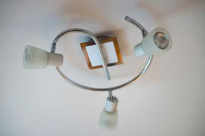 a lamp with a mirror and a picture at Apartma Ela in Bled