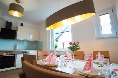 a kitchen with a table with pink paper boats on it at Apartma Ela in Bled