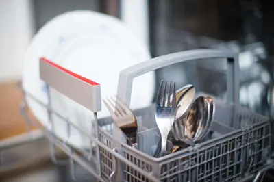 a dish drying rack with utensils in it at Apartma Ela in Bled